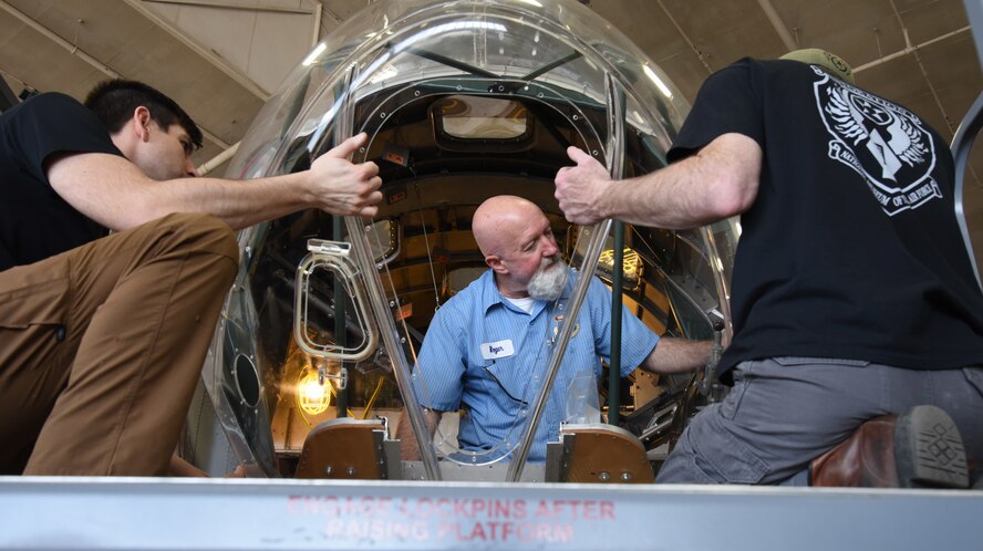 (02/26/2018) -- Museum restoration specialists Casey Simmons, Roger Brigner and Chad Vanhook attach the nose cone onto the Boeing B-17F Memphis Belle. Plans call for the aircraft to be placed on permanent public display in the WWII Gallery here at the National Museum of the U.S. Air Force on May 17, 2018. (U.S. Air Force photo by Ken LaRock)