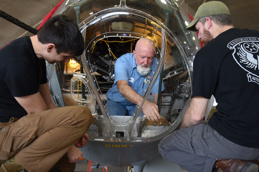 (02/26/2018) -- Museum restoration specialists Casey Simmons, Roger Brigner and Chad Vanhook attach the nose cone onto the Boeing B-17F Memphis Belle. Plans call for the aircraft to be placed on permanent public display in the WWII Gallery here at the National Museum of the U.S. Air Force on May 17, 2018. (U.S. Air Force photo by Ken LaRock)