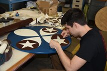 02/28/2018) -- Museum restoration specialist Casey Simmons works on the wheel covers for the Boeing B-17F Memphis Belle. Plans call for the aircraft to be placed on permanent public display in the WWII Gallery here at the National Museum of the U.S. Air Force on May 17, 2018. (U.S. Air Force photo by Ken LaRock)