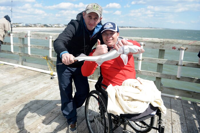 Georgia Army Cpl. Alika Gitolendia, right, and Sgt. Vepkhvia Gelashvili, members of the 2018 Marine Corps Trials Georgian team pose with a small shark caught while fishing at Ocean Crest Pier in Oak Island, N.C., March 14, 2018, as part of the USO of North Carolina’s “American Experience Day.” The Marine Corps Trials promotes recovery and rehabilitation through adaptive sport participation and develops camaraderie among recovering service members and veterans. It is as an opportunity for RSMs to demonstrate their achievements and serves as the primary venue to select Marine Corps participants for the DoD Warrior Games.