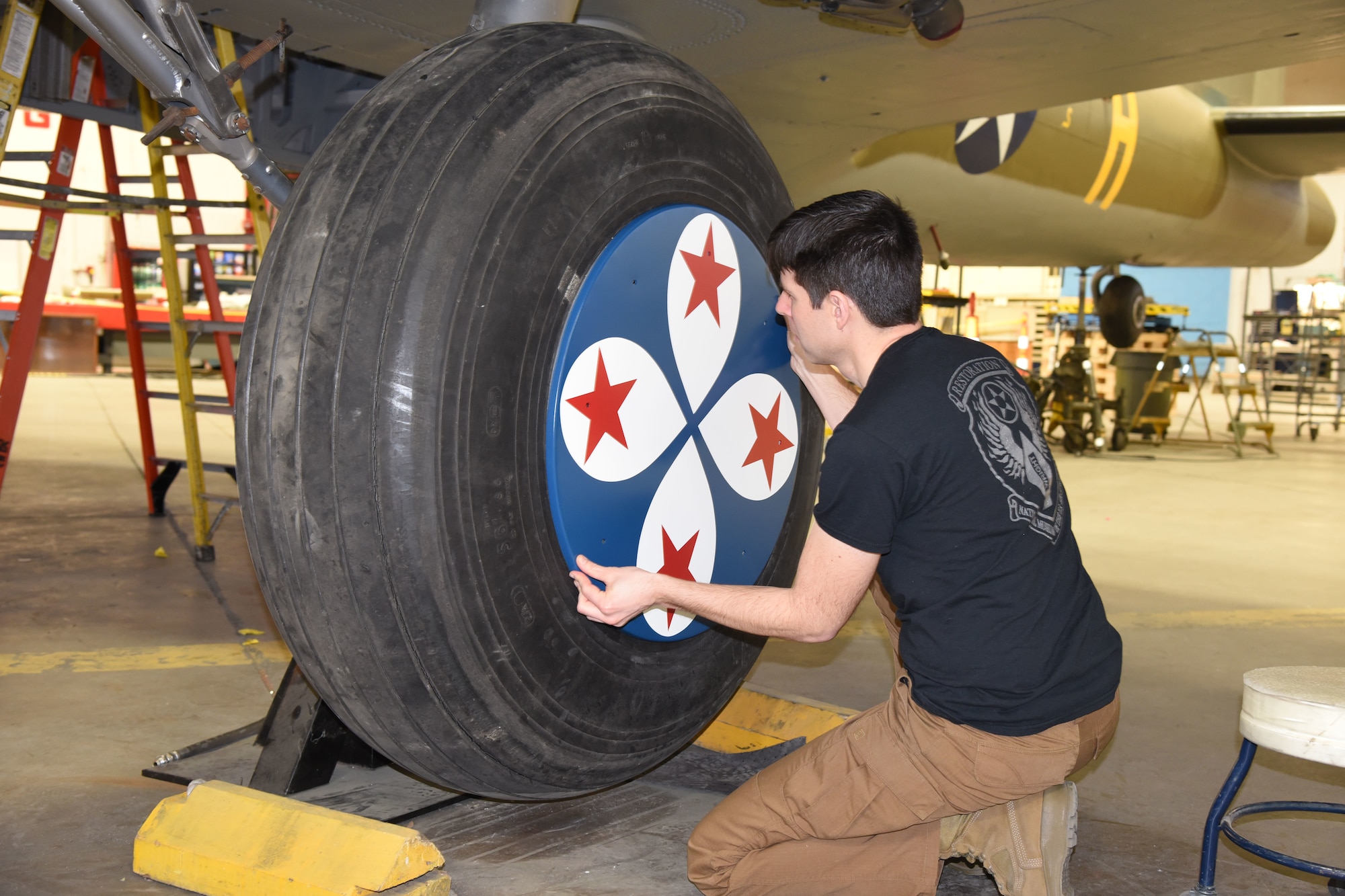 (03/01/2018) -- Museum restoration specialist Casey Simmons test fits the wheel covers on the Boeing B-17F Memphis Belle. Plans call for the aircraft to be placed on permanent public display in the WWII Gallery here at the National Museum of the U.S. Air Force on May 17, 2018. (U.S. Air Force photo by Ken LaRock)