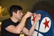(03/01/2018) -- Museum restoration specialist Casey Simmons test fits the wheel covers on the Boeing B-17F Memphis Belle. Plans call for the aircraft to be placed on permanent public display in the WWII Gallery here at the National Museum of the U.S. Air Force on May 17, 2018. (U.S. Air Force photo by Ken LaRock)
