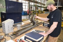 (03/01/2018) -- Museum restoration specialist Chad Vanhook inspects .50 cal ammo for display in the Boeing B-17F Memphis Belle. Plans call for the aircraft to be placed on permanent public display in the WWII Gallery here at the National Museum of the U.S. Air Force on May 17, 2018. (U.S. Air Force photo by Ken LaRock)