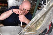 (03/01/2018) -- Museum restoration specialist Duane Jones works in the nose of the Boeing B-17F Memphis Belle. Plans call for the aircraft to be placed on permanent public display in the WWII Gallery here at the National Museum of the U.S. Air Force on May 17, 2018. (U.S. Air Force photo by Ken LaRock)