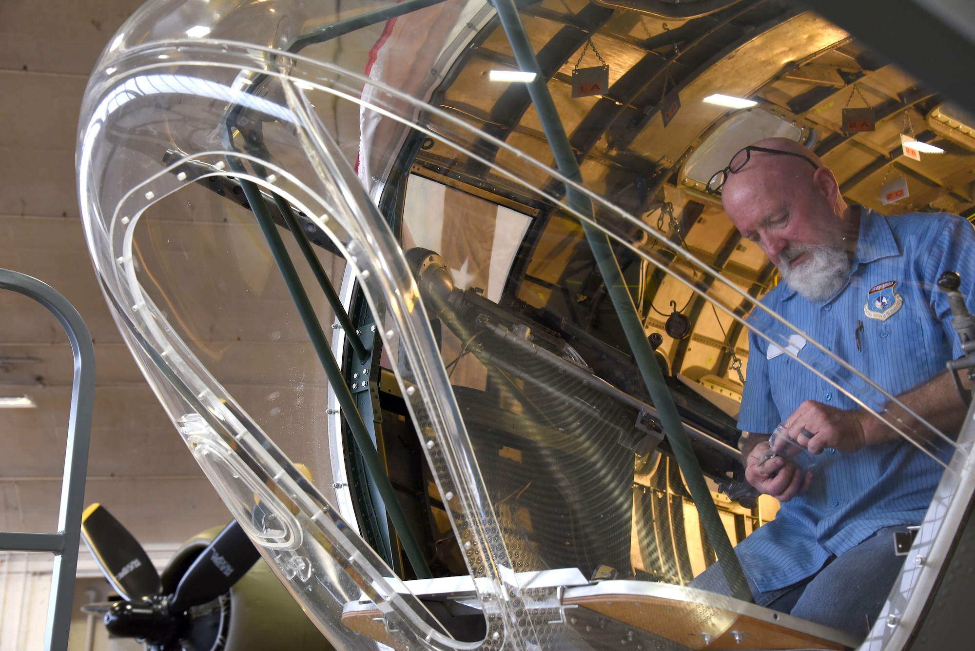 (03/06/2018) -- Museum restoration specialist Roger Brigner works on the bomb sight mount in the Boeing B-17F Memphis Belle. Plans call for the aircraft to be placed on permanent public display in the WWII Gallery here at the National Museum of the U.S. Air Force on May 17, 2018. (U.S. Air Force photo by Ken LaRock)
