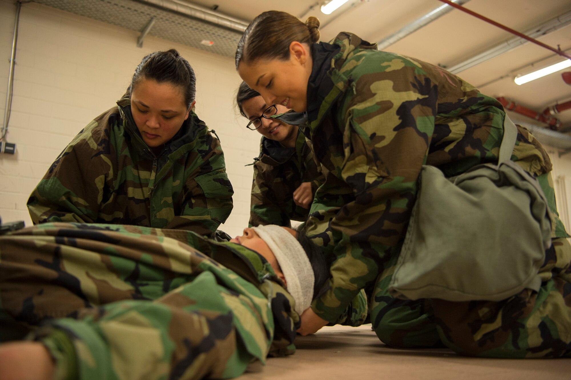 Airmen assigned to the 52nd Fighter wing execute Self Aid Buddy Care procedures during Ability to Survive and Operate training at Spangdahlem Air Base, Germany, March 8, 2018. ATSO training has proven to be effective in not only improving an Airman’s abilities to perform their duties during less-than-ideal circumstances, but also in preparing the wing populous to respond to CBRN threats or attacks. (U.S. Air Force photo by Senior Airman Dawn M. Weber)