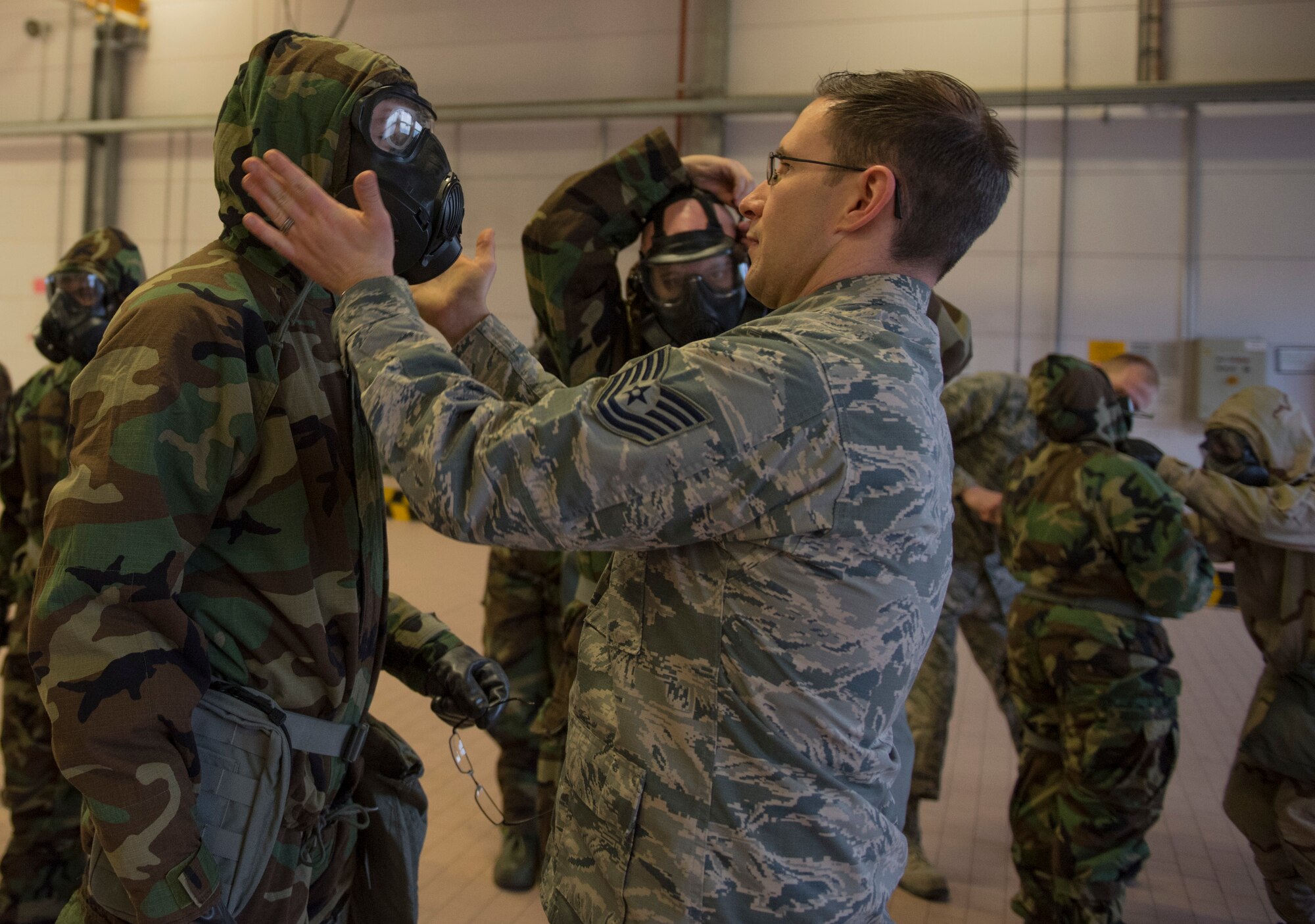 U.S. Air Force Tech. Sgt. Timothy Bennett, 52nd Civil Engineer Squadron emergency management craftsman, tests the seals on the M45 Land Warrior Chemical Biological Mask during Ability to Survive and Operate training at Spangdahlem Air Base, Germany, March 8, 2018. With a high level of importance placed on the ability to respond to external threats quickly and effectively, the 52nd CES conducted refresher training for everyone from the most novice Airmen to the most combat-experienced Chief. (U.S. Air Force photo by Airman 1st Class Jovante Johnson)