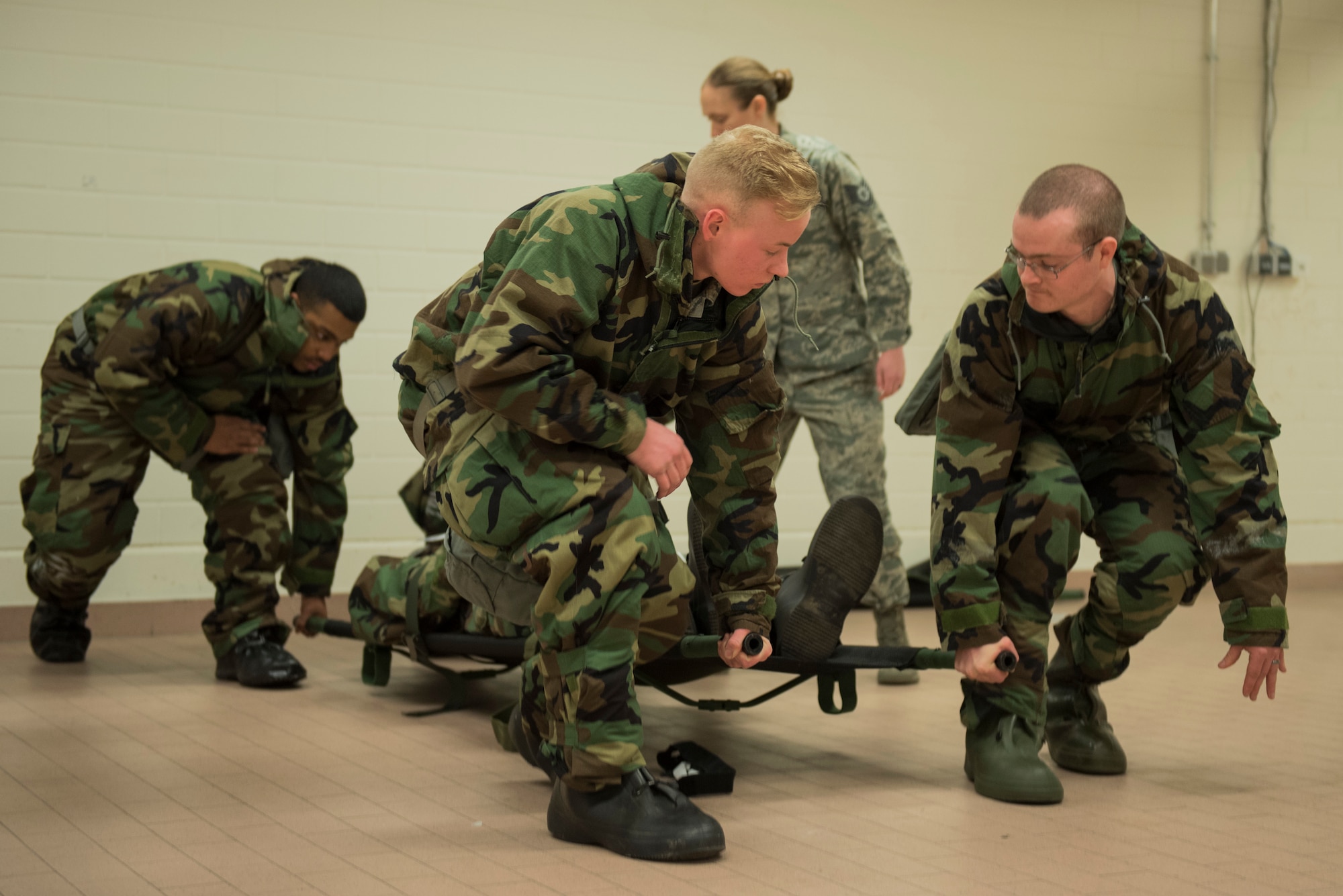 Airmen from the 52nd Fighter Wing perform litter carries during Ability to Survive and Operate training at Spangdahlem Air Base, Germany, March 8, 2018. With a high level of importance placed on the ability to respond to external threats quickly and effectively, the 52nd CES conducted refresher training for everyone from the most novice Airmen to the most combat-experienced Chief. (U.S. Air Force photo by Airman 1st Class Jovante Johnson)