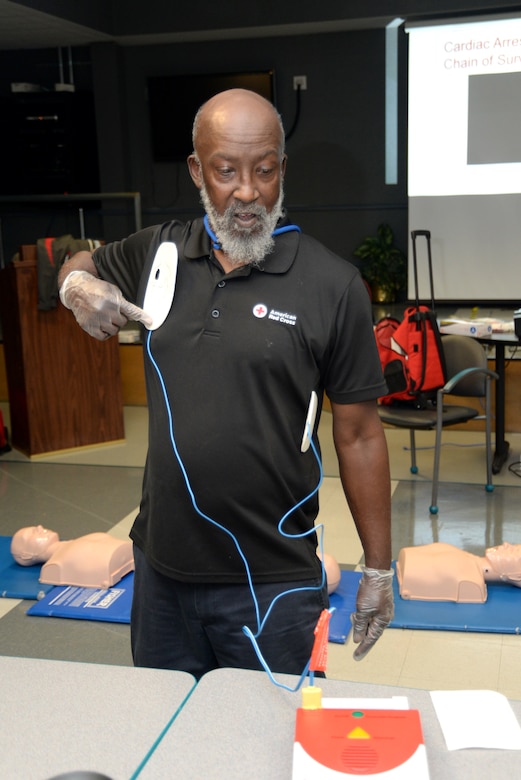 Red Cross instructor Victor Churchill shows the correct placement of the automated external defibrillator pads during a first aid and CPR training and certification session for 12 employees of the U.S. Army Engineering and Support Center, Huntsville, March 1, 2018. Along with their primary duties, the employees serve as first aid attendants for Huntsville Center and must certify annually.