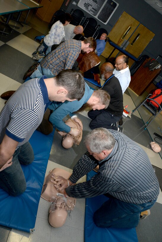 Employees of the U.S. Army Engineering and Support Center, Huntsville, practice alternating chest compressions and rescue breaths on medical dummies during a first aid and CPR training and certification session March 1 at the Center. Along with their primary duties, the employees serve as first aid attendants for Huntsville Center and must certify annually.