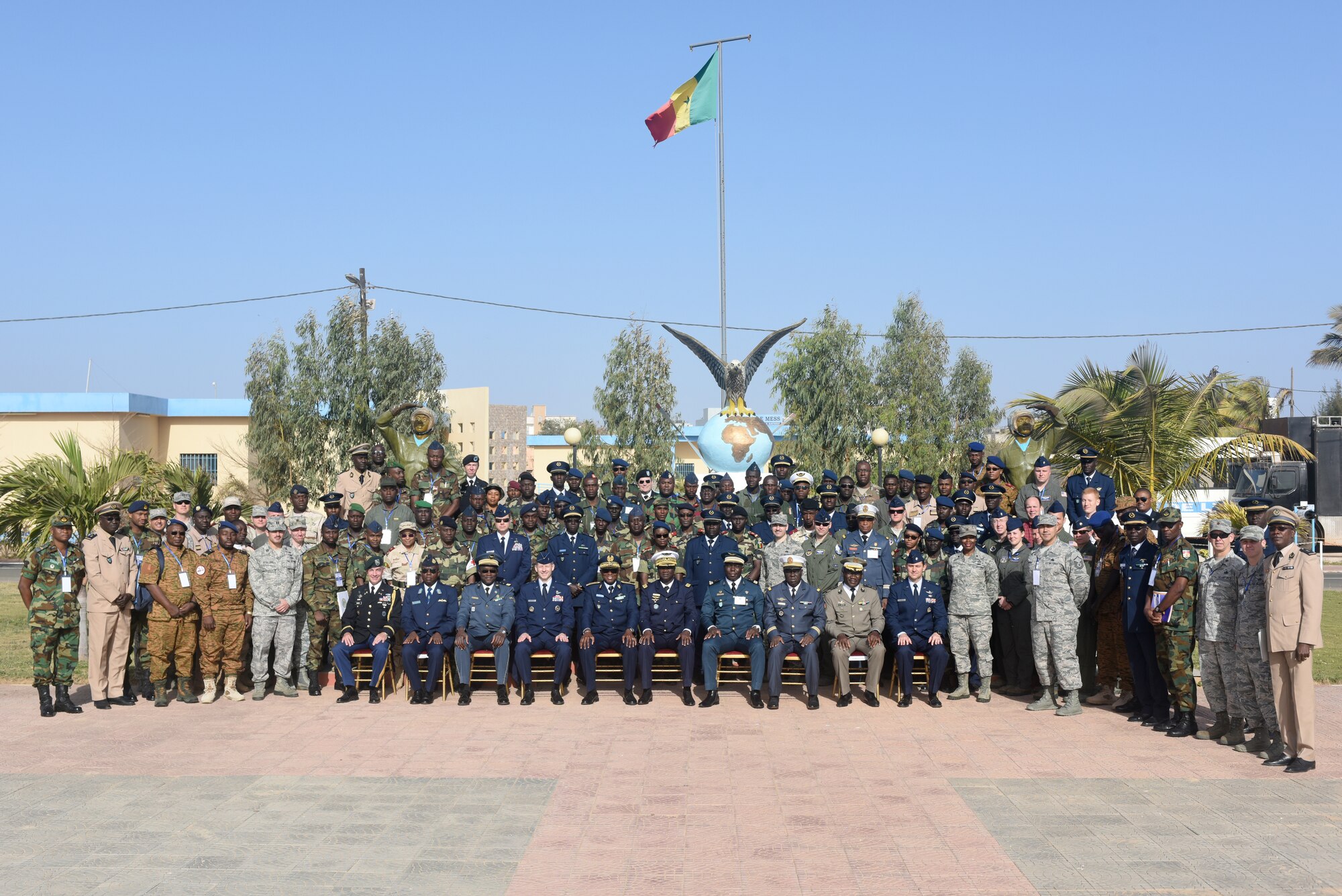 Participants of African Partnership Flight Senegal pose for a photo after the opening ceremony of APF at Captain Andalla Cissé Air Base, Senegal, March 19, 2018. Ten nations are participating in this event, which will focus on casualty evacuation, aeromedical evacuation, as well as air and ground safety. (U.S. Air Force photo by Airman 1st Class Eli Chevalier)