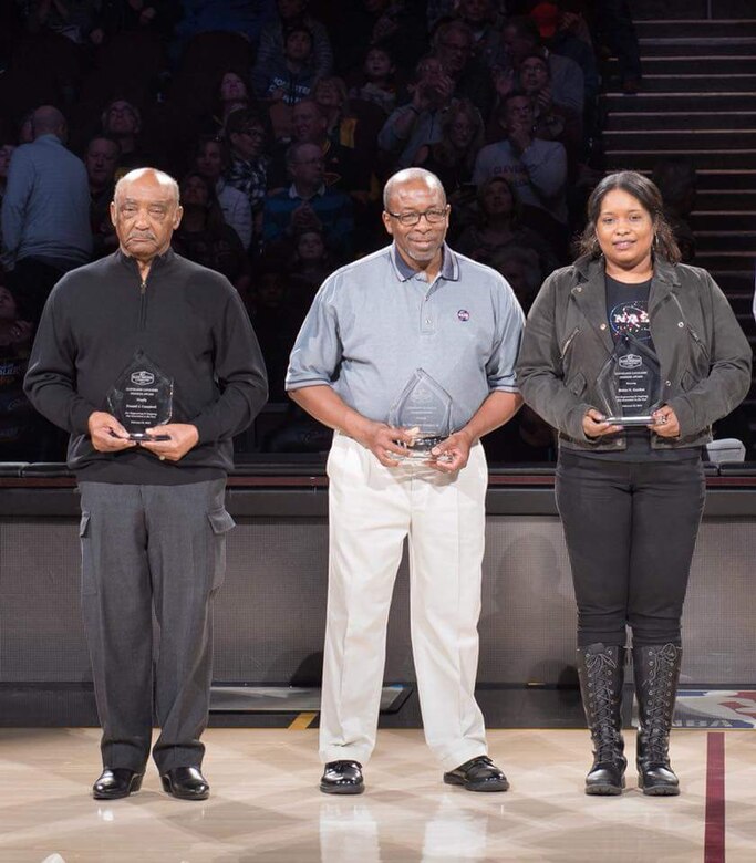 Dr. Woodrow Whitlow, Jr., center, technical director for the AEDC Test Operations and Sustainment contractor, receives recognition at the Cleveland Cavaliers half-time Feb. 25 as part of a Black Heritage Celebration honoring pioneers in space travel. Whitlow was the first African-American director of Research and Technology at NASA Glenn Research Center (GRC) in Cleveland, Ohio, and served in this role from September 1998 until September 2003. Also honored for their NASA contributions and leadership at GRC were Donald Campbell (left) and Robyn Gordon (right). (Courtesy photos)