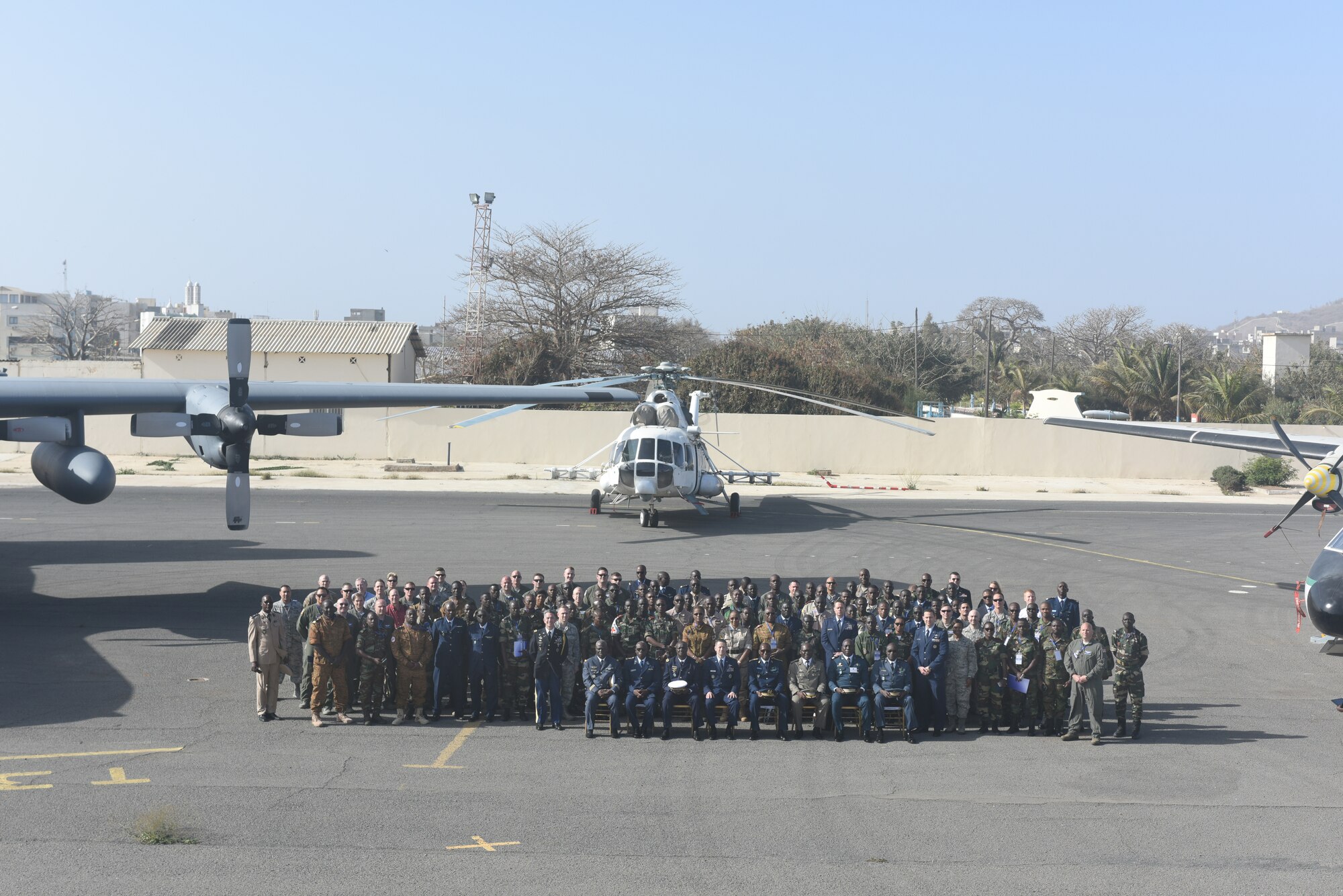 Participants of African Partnership Flight Senegal pose for a photo after the opening ceremony of the week-long aviation engagement at Captain Andalla Cissé Air Base, Senegal, March 19, 2018. Ten nations are participating in this event, which will focus on casualty evacuation, aeromedical evacuation, as well as air and ground safety. (U.S. Air Force photo by Airman 1st Class Eli Chevalier)