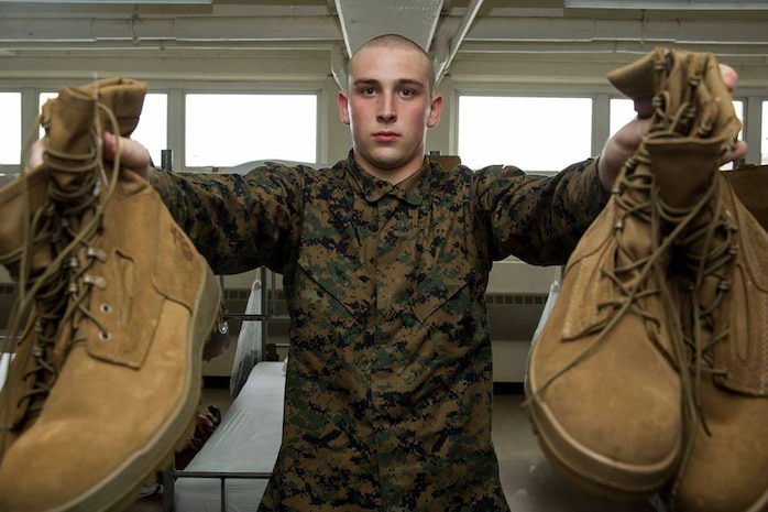 A recruit from Delta Company, 1st Recruit Training Battalion, holds out his boots during pick up at Marine Corps Recruit Depot San Diego, March 9. This is part of an initial gear inspection recruits must go through to ensure they have all the required gear needed for recruit training. Annually, more than 17,000 males recruited from the Western Recruiting Region are trained at MCRD San Diego. Delta Company is scheduled to graduate June 1.
 (Photo by: Lance Cpl Christian M. Garcia)