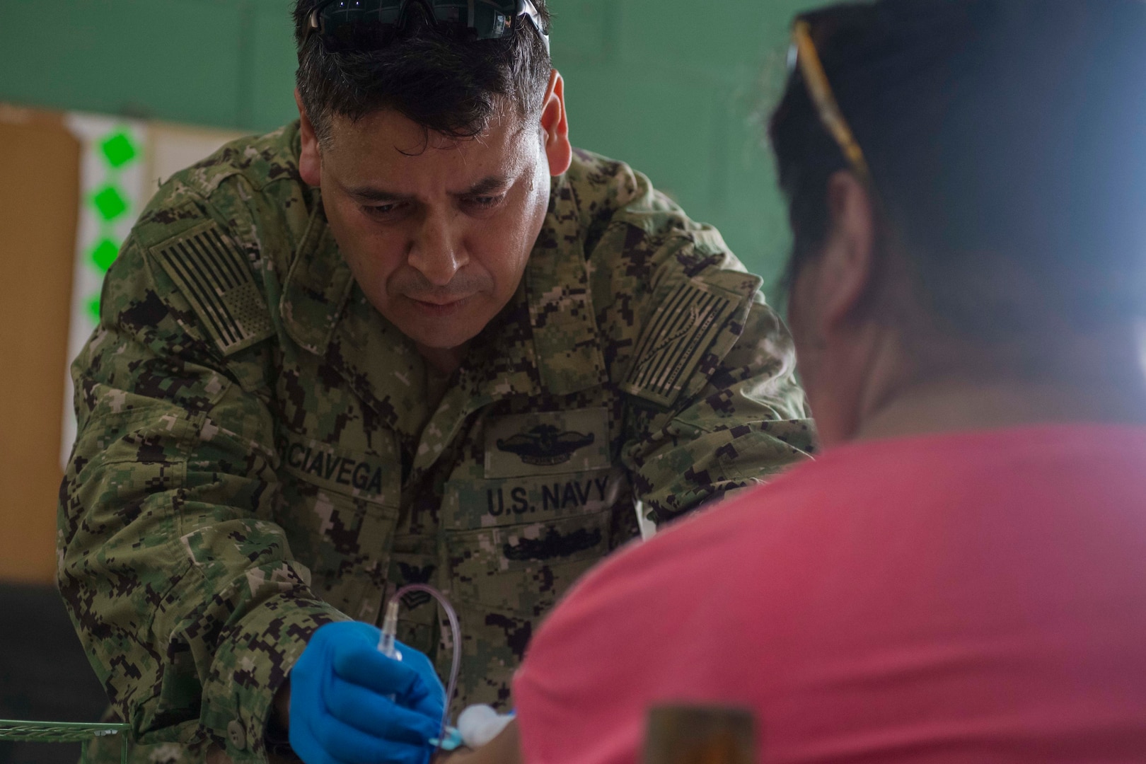 A doctor takes a blood sample from a patient.