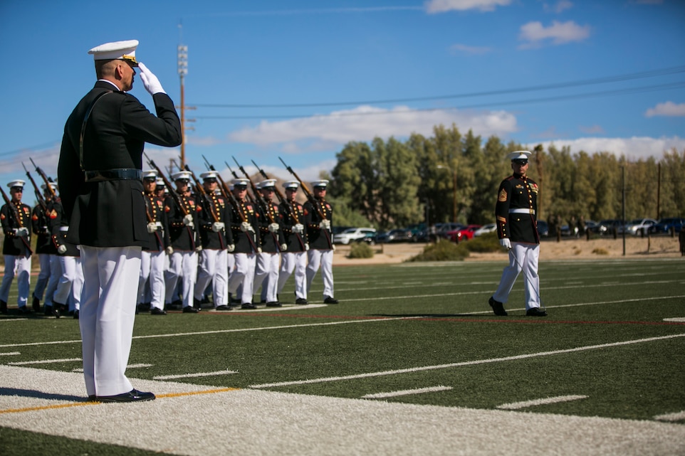 The U.S. Marine Corps Silent Drill Platoon, Battle Colors Detachment, Marine Barracks Washington, D.C., executes a pass and review in front of Maj. General William F. Mullen III, commanding general, Marine Corps Air Ground Combat Center, Twentynine Palms, Calif., during the Battle Colors Ceremony at Felix Field, March 14, 2018. The ceremony is held to honor Marine Corps traditions through the Drum Corps, the Silent Drill Platoon and the Battle Colors Detachment. (U.S. Marine Corps photo by Lance Cpl. Margaret Gale)