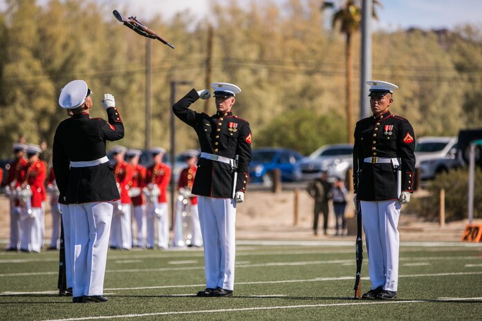 The U.S Marine Corps Silent Drill Platoon, Battle Colors Detachment, Marine Barracks Washington, D.C., performs during the Battle Colors Ceremony at Felix Field aboard the Marine Corps Air Ground Combat Center, Twentynine Palms, Calif., March 14, 2018. The ceremony is held to honor Marine Corps traditions through the Drum Corps, the Silent Drill Platoon and the Battle Colors Detachment.  (U.S. Marine Corps photo by Lance Cpl. Margaret Gale)