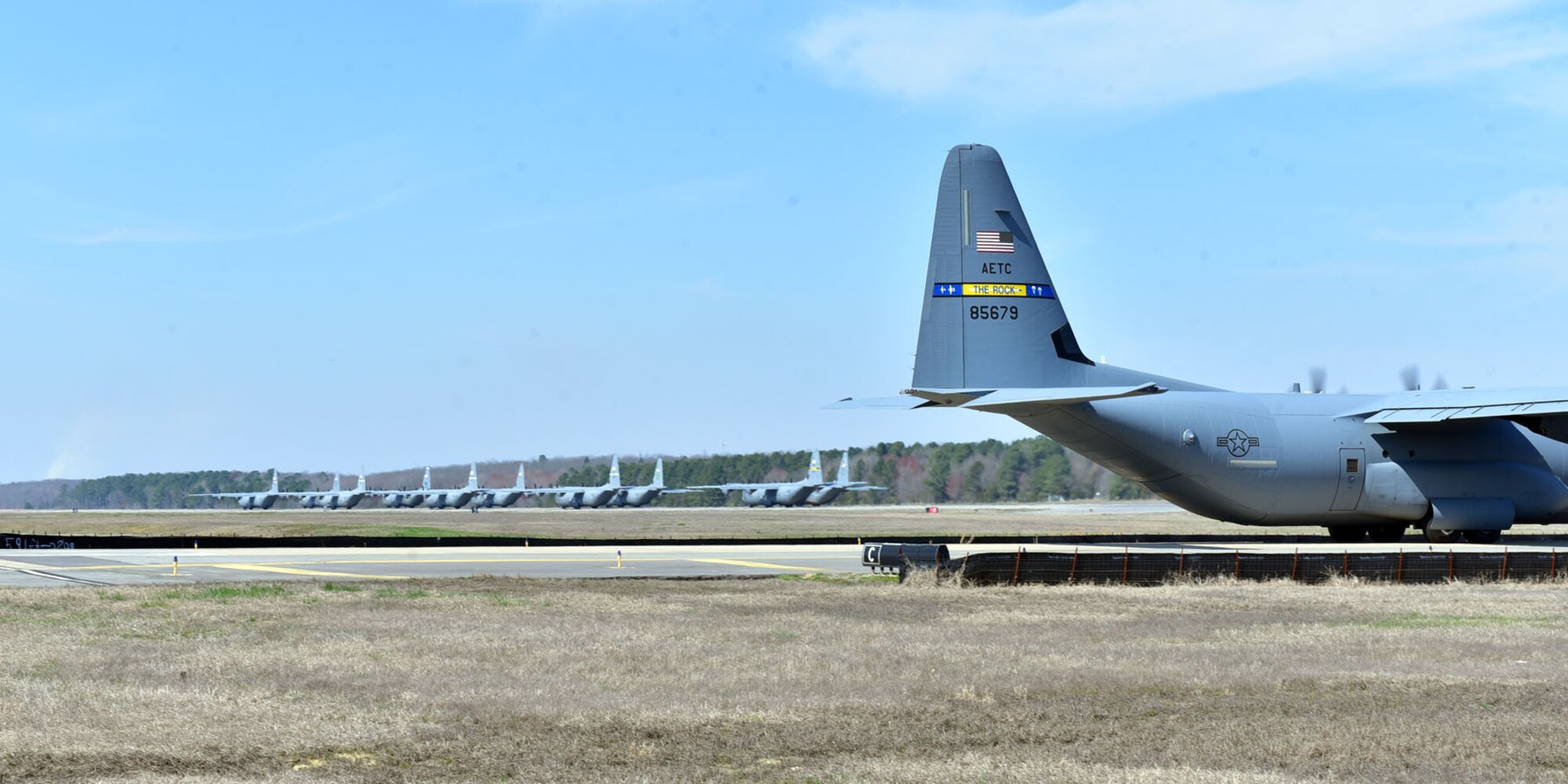 Ten C-130J aircraft occupy the runway before take-off Mar. 15, 2018, at Little Rock Air Force Base, Ark. Aircraft from seven units around the world participated in the 19-aircraft formation, which was designed to enhance skills of pilots and aircrew during large formation operations.  . (U.S. Air Force photo by Airman 1st Class Rhett Isbell/Released)