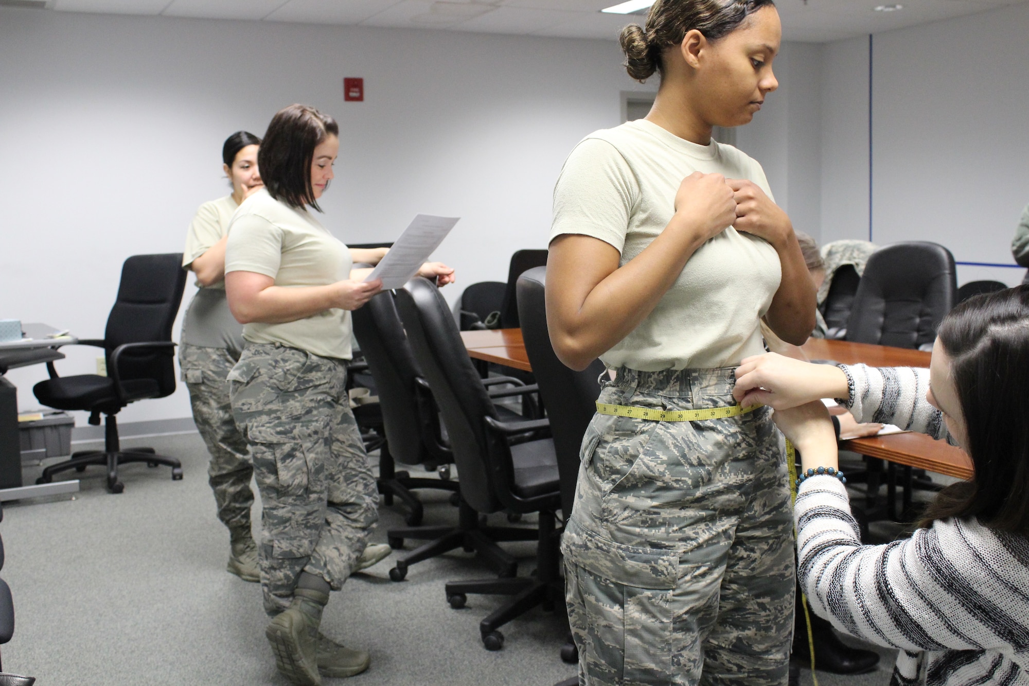 Stacey Butler, a clothing designer with the AFLCMC Air Force Uniform Office, measures Staff Sgt. Kierra McCray, executive to the AFLCMC command chief. As part of the design and development process, female Airmen volunteered to be measured by the uniform office team to see if their measurements would qualify them to try on the sample size of the newly designed women’s slacks. (U.S. Air Force Photo/Stacey Geiger)