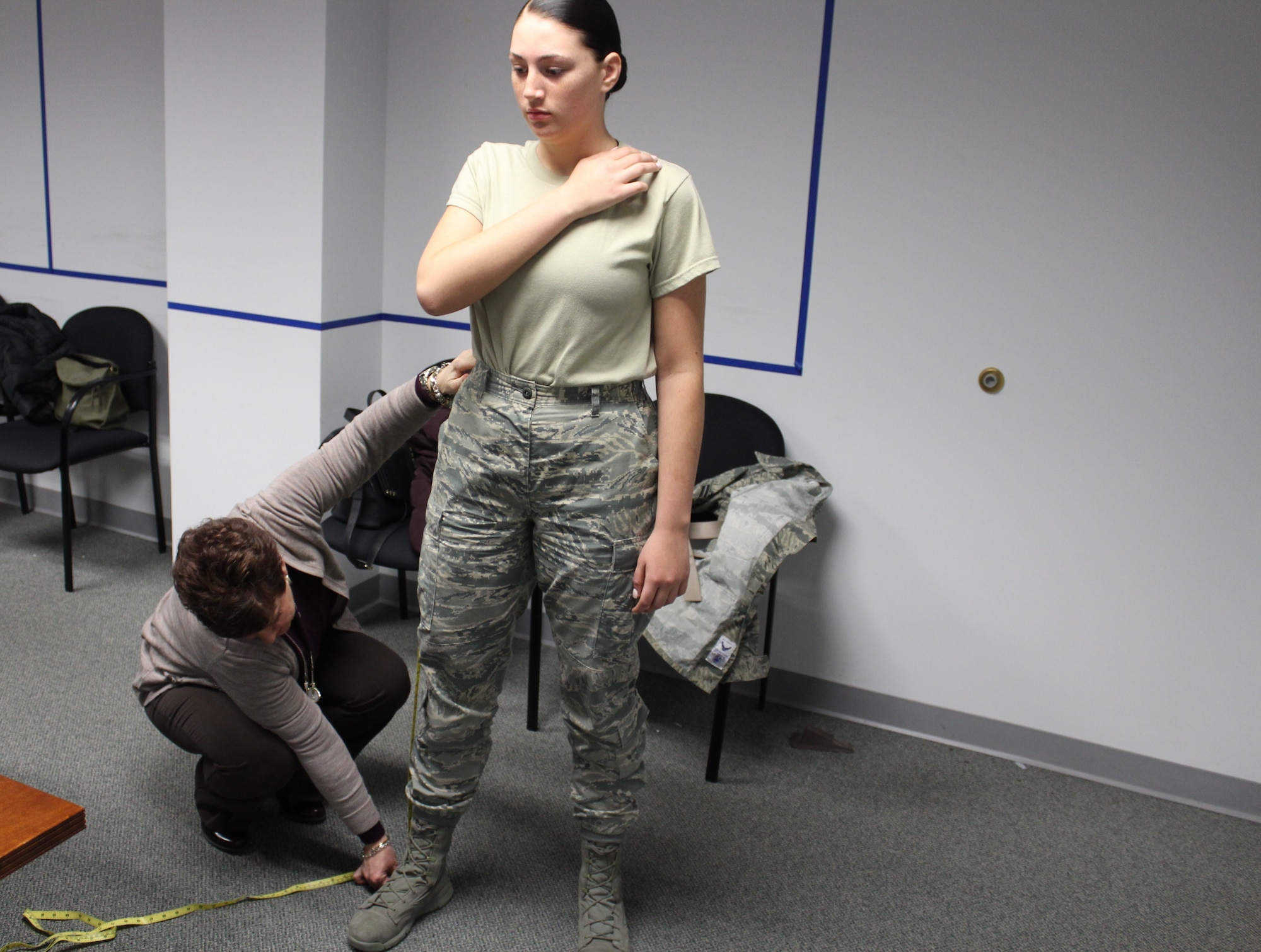 Tracy Roan, Air Force Uniform Office Chief, measures Airman 1st Class Madison Gilbert, an administrative technician in the AFLCMC Director of Staff’s office, to see if she fits the measurements to try on the sample pair of the newly designed female slacks. As part of the prototype development phase, the technical team conducts fit evaluations to determine what modifications need to be made to achieve a final prototype (U.S. Air Force Photo/Stacey Geiger)