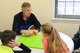 Arnold AFB STEM Coordinator Jere Matty with a group of children from Arnold Village