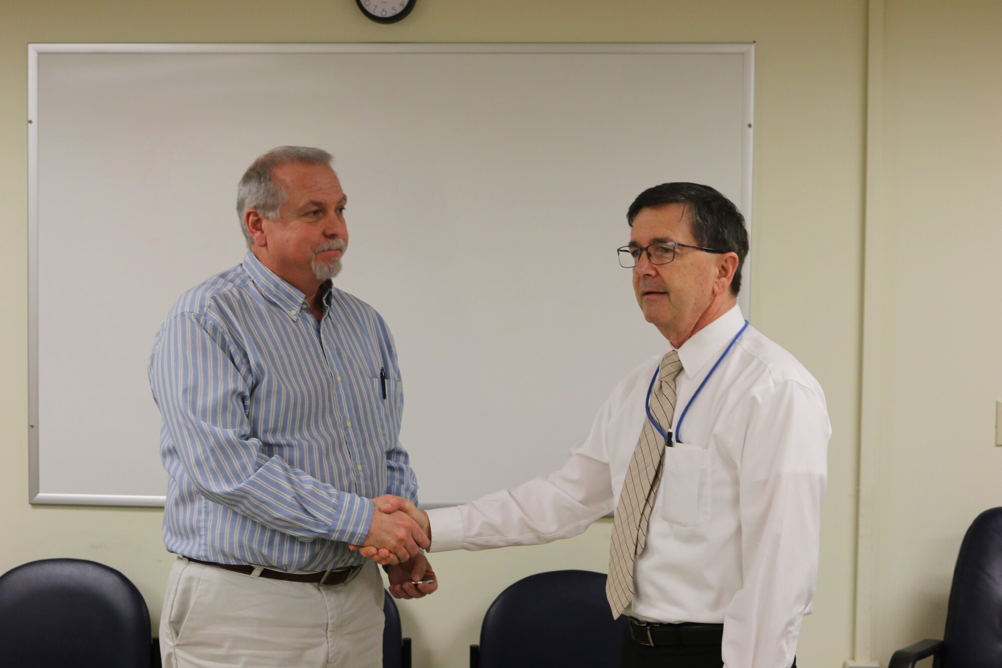 Arnold Air Force Base Technology/Manufacturing Planner and Scheduler Jeff Tate left, receives a commemorative coin of appreciation from Technology/Manufacturing Branch Manager Mark Chappell.