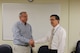 Arnold Air Force Base Technology/Manufacturing Planner and Scheduler Jeff Tate left, receives a commemorative coin of appreciation from Technology/Manufacturing Branch Manager Mark Chappell.