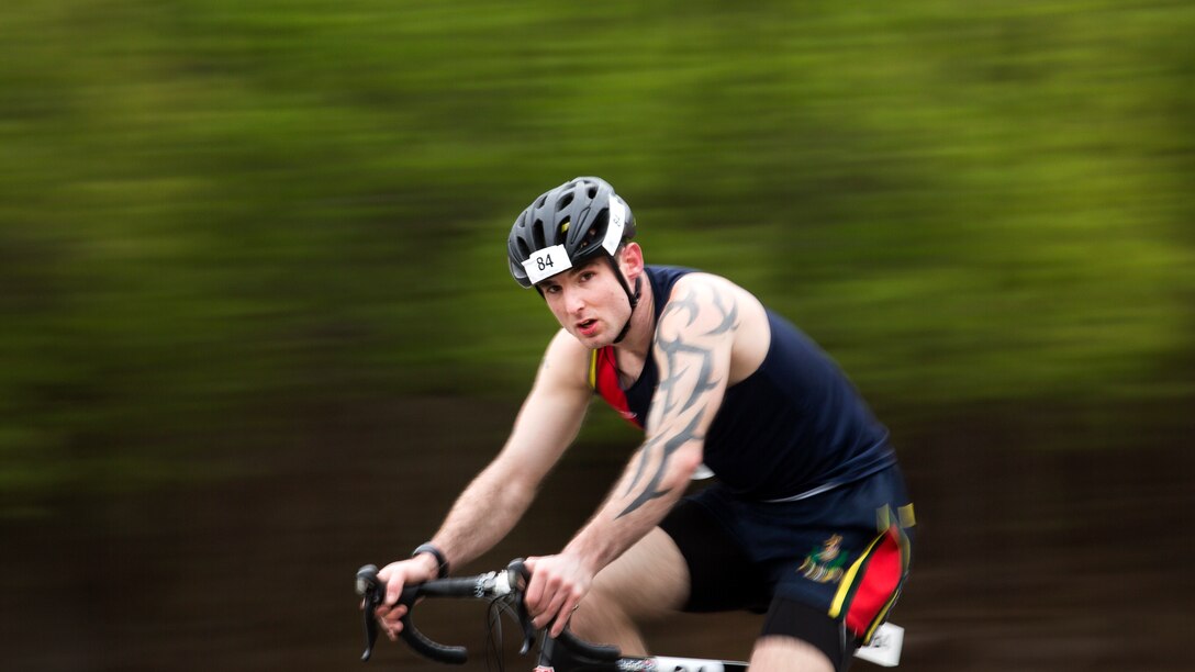 Royal Marine Connor Moore races down Holcomb Boulevard at the 2018 Marine Corps Trials cycling competition at Marine Corps Base Camp Lejeune, N.C., March 18, 2018. The Marine Corps Trials promotes recovery and rehabilitation through adaptive sport participation and develops camaraderie among recovering service members and veterans. It is as an opportunity for RSMs to demonstrate their achievements and serves as the primary venue to select Marine Corps participants for the DoD Warrior Games.