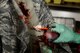 U.S. Air Force Lt. Col. Cheryl Lockheart, 20th Medical Group chief nurse, applies fake blood onto an exercise participant during an active threat exercise at Shaw Air Force Base, S.C., March 16, 2018.