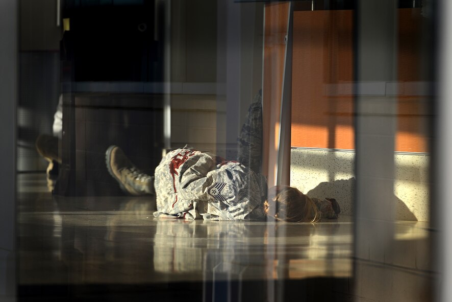 A simulated casualty lies on the ground during an active threat exercise at Shaw Air Force Base, S.C., March 16, 2018.