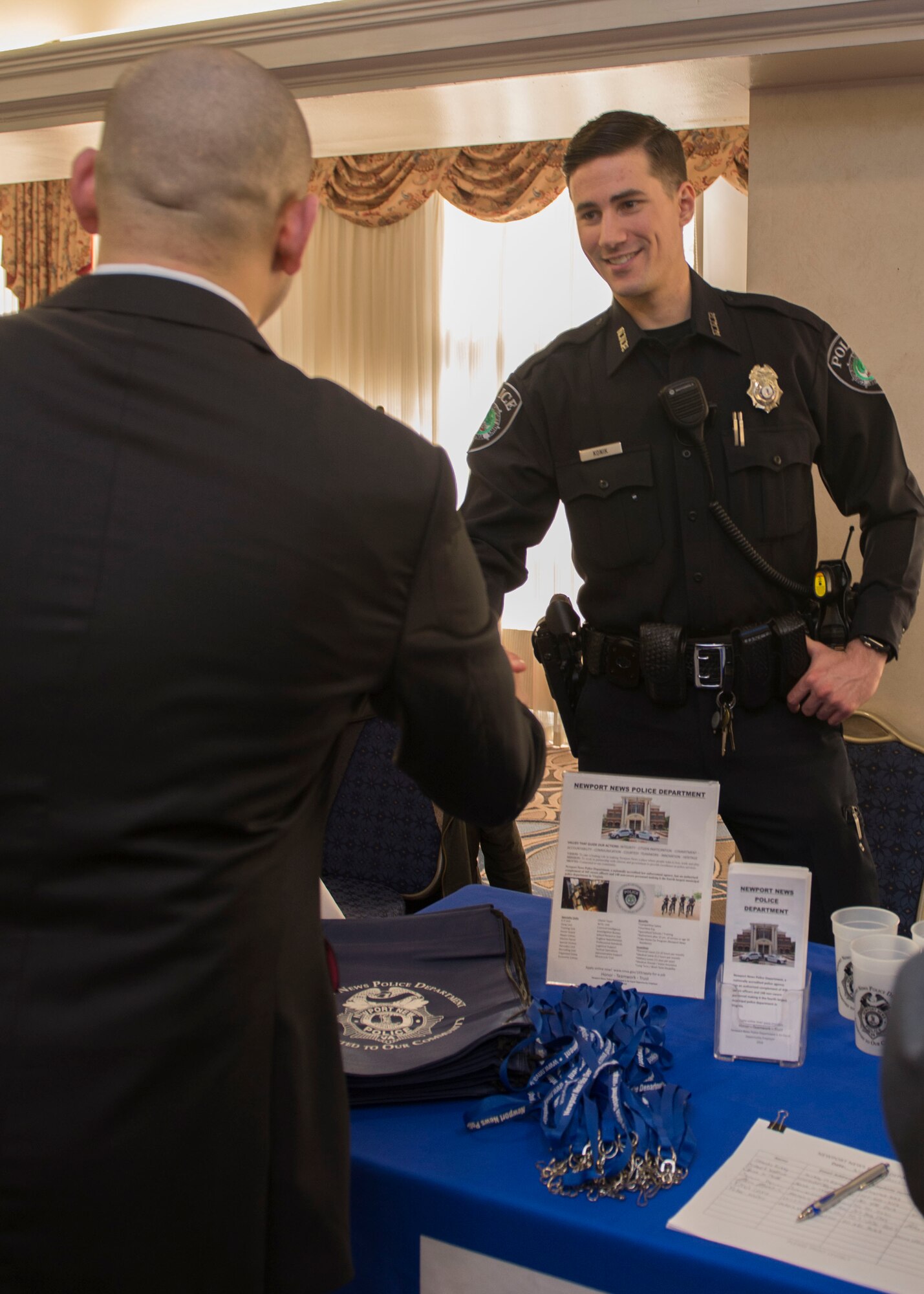 Daniel Konik, Newport News Police Department police officer, gives information about job opportunities at the Fort Eustis Club on Joint Base Langley-Eustis, Virginia, March 15, 2018.