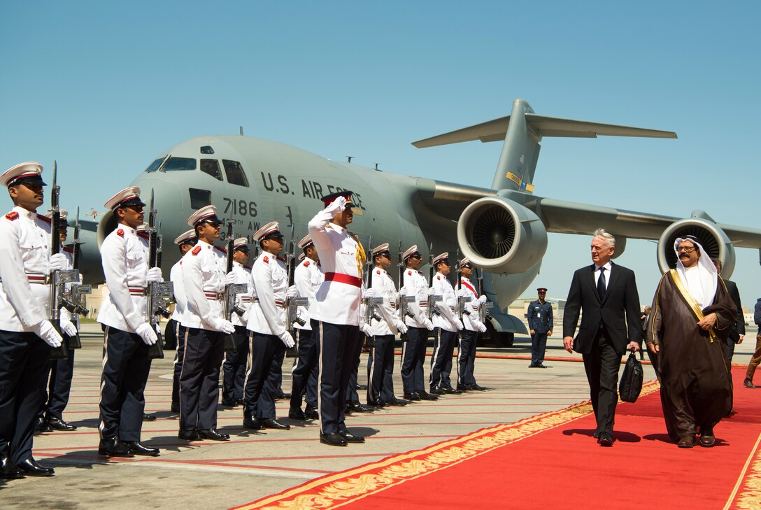 Defense Secretary James N. Mattis walks on a red carpet with Bahraini Defense Minister Lt. Gen. Shaikh Yousuf bin Ahmed bin Hussain Al Jalahma.