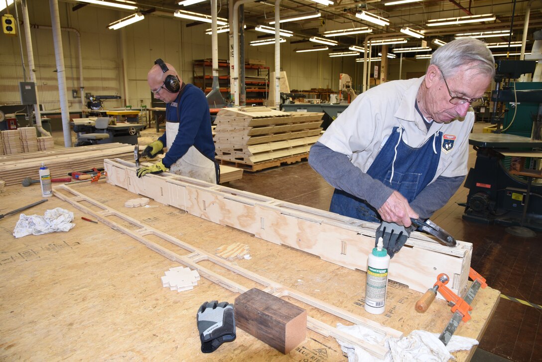 (12/12/2017) -- National Museum of the U.S. Air Force Exhibits Specialist Tony Cerra and volunteer Adam Zengel construct curbing for the exhibit wall panels in the new Memphis Belle exhibit. Plans call for the Memphis Belle aircraft to be placed on permanent public display in the WWII Gallery here at the National Museum of the U.S. Air Force on May 17, 2018. (U.S. Air Force photo by Ken LaRock)