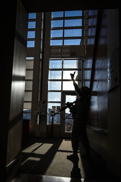 U.S. Air Force Tech. Sgt. Cecy Hunter, 20th Security Forces Squadron (SFS) flight chief, signals to her team during an active threat exercise at Shaw Air Force Base, S.C., March 16, 2018.