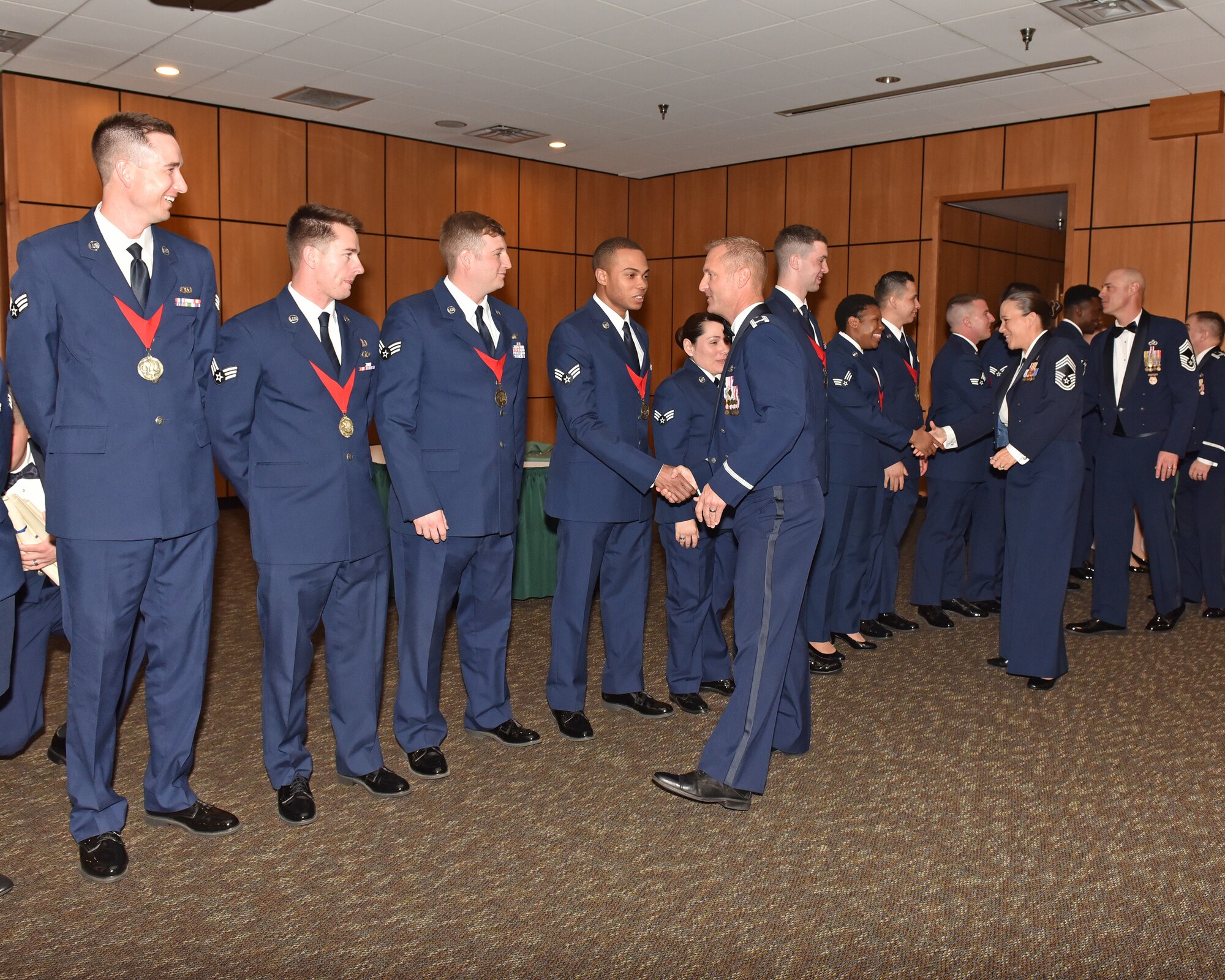 Vice commander congratulates the graduates of Airmen Leadership School.