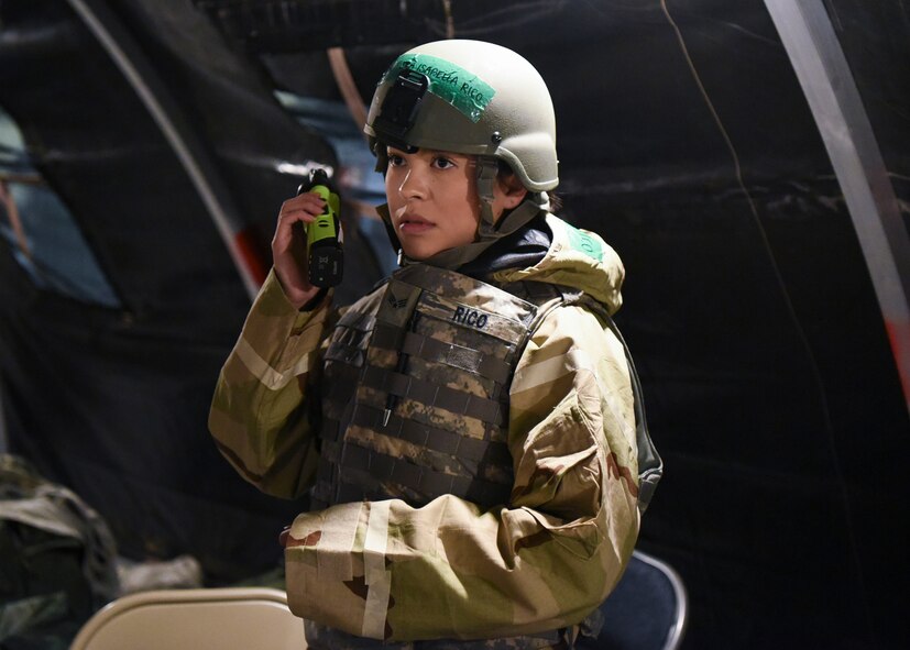 U.S. Air Force Senior Airman Isabella Rico, a 319th Operations Support air traffic controller, talks through a hand-held radio on Grand Forks Air Force Base, N.D., Feb. 28, 2018. Rico communicated to Airmen in the other tents to ensure they were following protocol during the exercise. (U.S. Air Force photo by Airman 1st Class Melody Wolff)