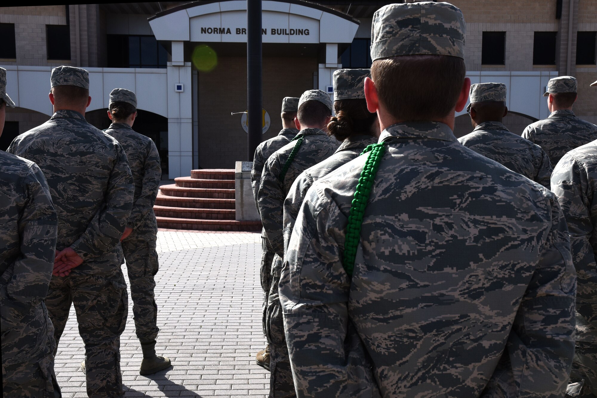 Goodfellow service members stand at parade rest, waiting for the flag to be lowered during the special retreat ceremony in honor of Women’s History Month at the Norma Brown Building on Goodfellow Air Force Base, Texas, March 16, 2018. This was one of several events being held around base throughout the month. (U.S. Air Force photo by Airman 1st Class Seraiah Hines/Released)