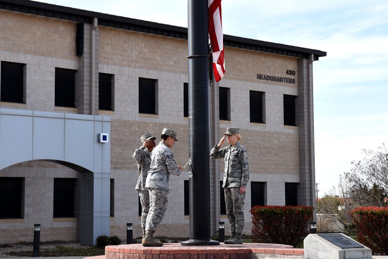 Members of the flag detail for the special retreat ceremony, lower the flag in front of the Norma Brown Building on Goodfellow Air Force Base, Texas, March 16, 2018. All service members were welcome to attend the event in honor of Women’s History Month. (U.S. Air Force photo by Airman 1st Class Seraiah Hines/ Released)