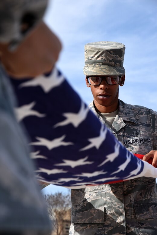 Staff Sgt. Anderia Hill, 17th Medical Group non-commissioned officer in charge of dental records and reception, folds the flag during the special retreat ceremony in front of the Norma Brown Building on Goodfellow Air Force Base, Texas, March 16, 2018. All service members are encouraged to attend the events in honor of Women’s History Month on base this month. (U.S. Air Force photo by Airman 1st Class Seraiah Hines/Released)