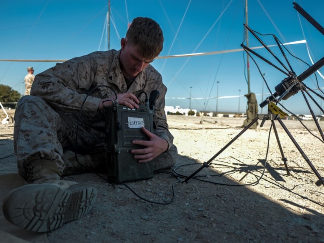 Cpl. Budrow, a radio operator from Bravo Company, programs a radio to establish single channel radio satellite communications capabilities during Native Fury in February.