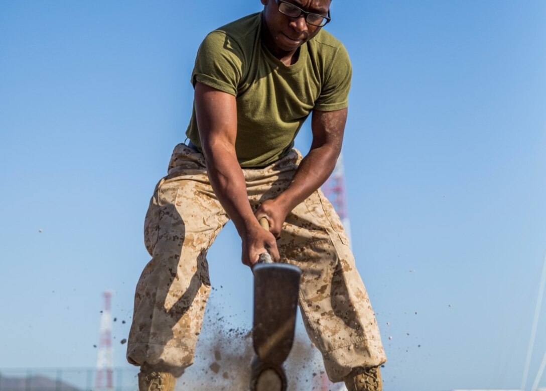 Lance Cpl. Simmons, Bravo Company, breaks a sweat while digging trenches to bury and protect fiber optic cables being ran between assets during Native Fury.