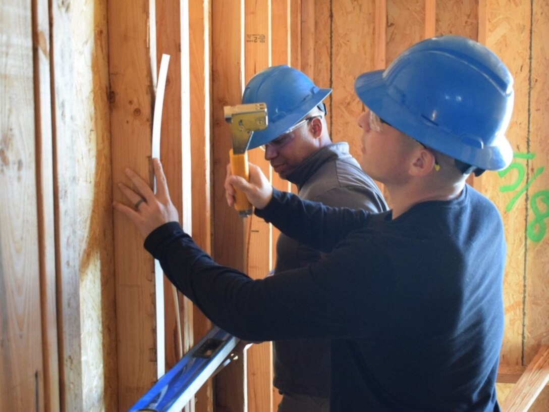 Sgt. Salcido and Sgt. Griffin-Benitez help build a house in San Diego County. The Marines of Bravo Company donated their time over two weeks to work with the San Diego Habitat for Humanity.