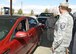 Master Sgt. Steven Dale and Master Sgt. Venessa Brown surprise a lucky lady by paying for a fill-up and pumping her gas at the Express gas station March 14. The Edwards First Sergeants Council conducted a "random-act-of-kindness" event where they paid for and offered to pump gas for junior servicemembers and spouses. (U.S. Air Force photo by Kenji Thuloweit)