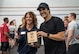 Sherri Biringer, 56th Force Support Squadron fitness specialist supervisor, receives the Reebok CrossFit Games Open 18.4 plaque from Dave Castro, Director of the Crossfit Games, at Luke Air Force Base, Ariz., March 15, 2018. The open is the first stage of the CrossFit Games season and the largest community CrossFit event of the year. (U.S. Air Force photo by Airman 1st Class Alexander Cook)