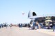 Thousands celebrate the landing of a parachute-man with the American flag here during the opening performance of the Luke Days Air Show, March 17, 2018. The air show attracts thousands of community members excited to see the Air Force Air Power. (U.S. Air National Guard photo by 1st Lt. Tinashe Machona)