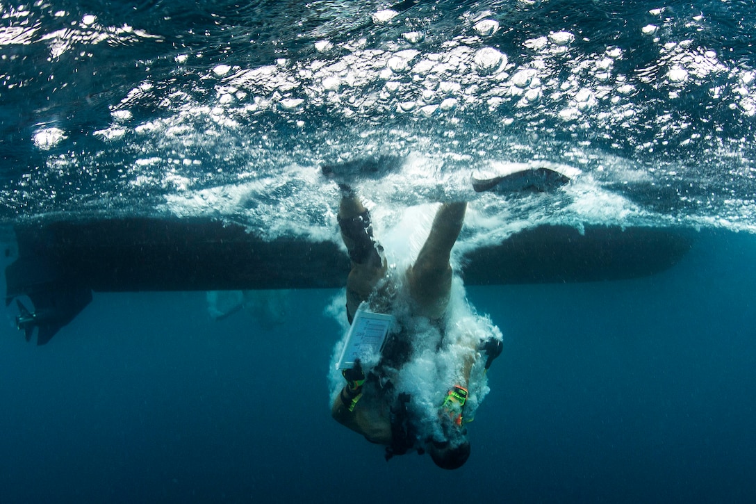 A diver enters the water.