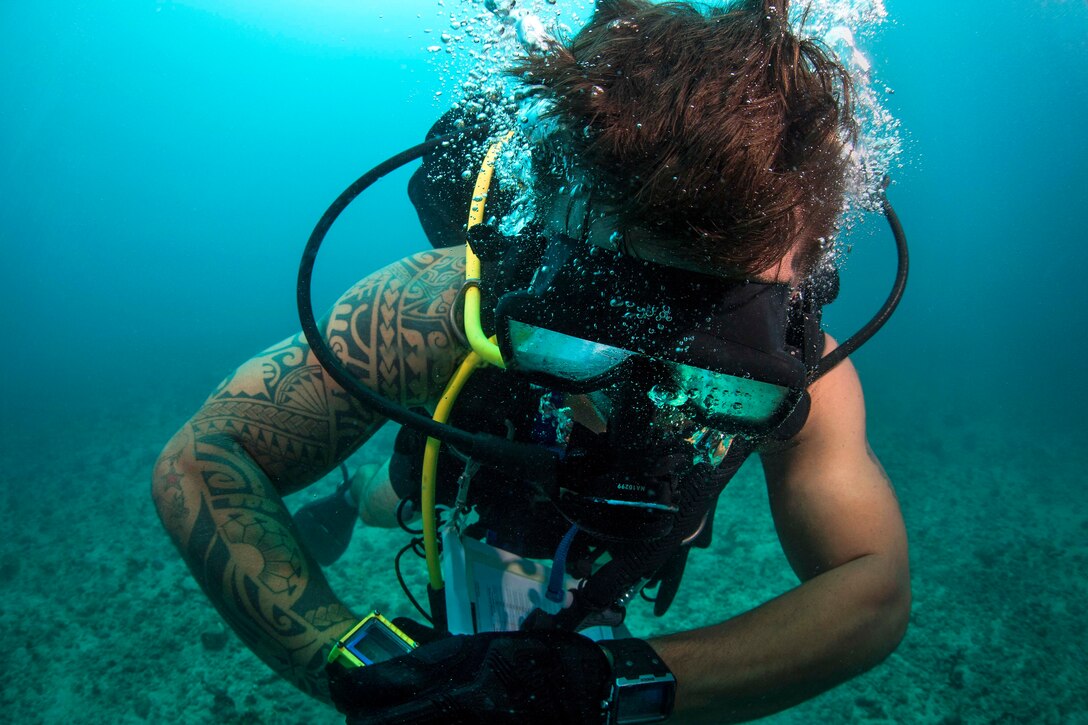 A diver checks his dive computer.