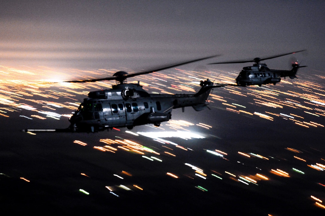 Two helicopters prepare to receive fuel.