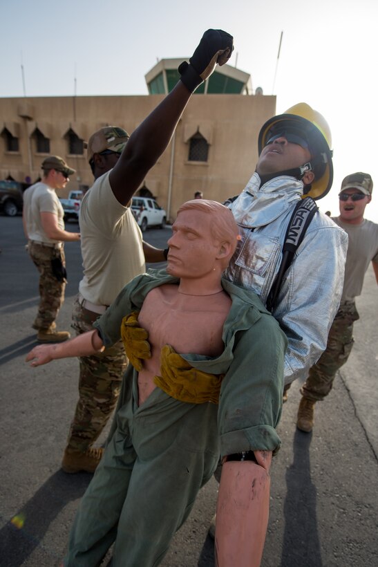 Members of the 379th Air Expeditionary Wing and Qatar Emiri Air Force participate in a firefighter challenge exercise at Al Udeid Air Base, Qatar, March 8, 2018. The a exercise, a strenuous course designed to test physical fitness and fire response capabilities, was organized by firefighters from the 379th ECES and Qatar Emiri Air Force. (U.S. Air Force photo by Staff Sgt. Joshua Horton)