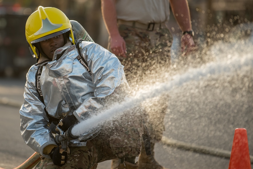 Members of the 379th Air Expeditionary Wing and Qatar Emiri Air Force participate in a firefighter challenge exercise at Al Udeid Air Base, Qatar, March 8, 2018. The a exercise, a strenuous course designed to test physical fitness and fire response capabilities, was organized by firefighters from the 379th ECES and Qatar Emiri Air Force. (U.S. Air Force photo by Staff Sgt. Joshua Horton)